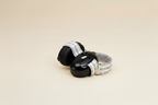 Little Nestlings Black Baby Ear Muffs on Cream Background